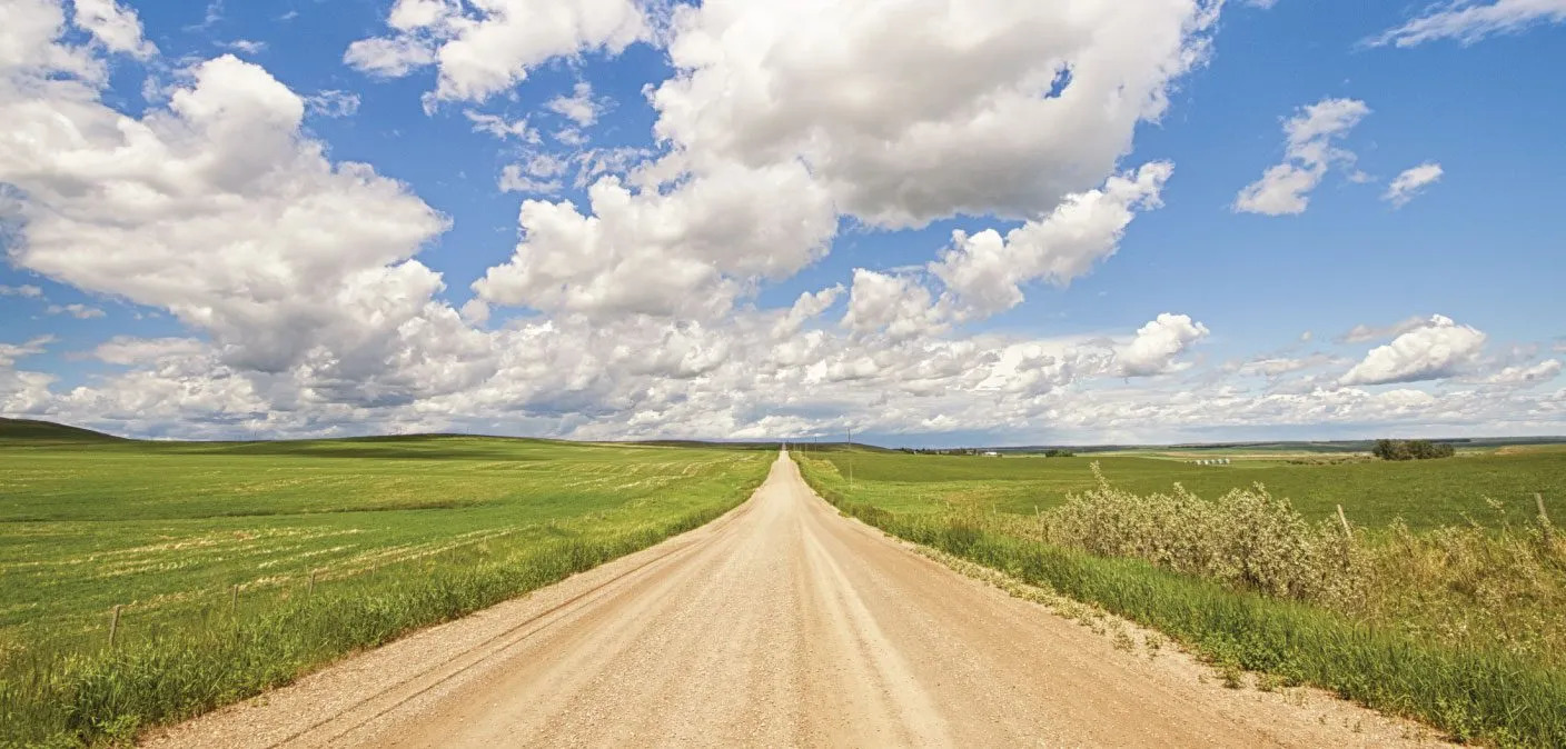 Goldwyn Balzac banner image showing a prairie road on a blue sky day