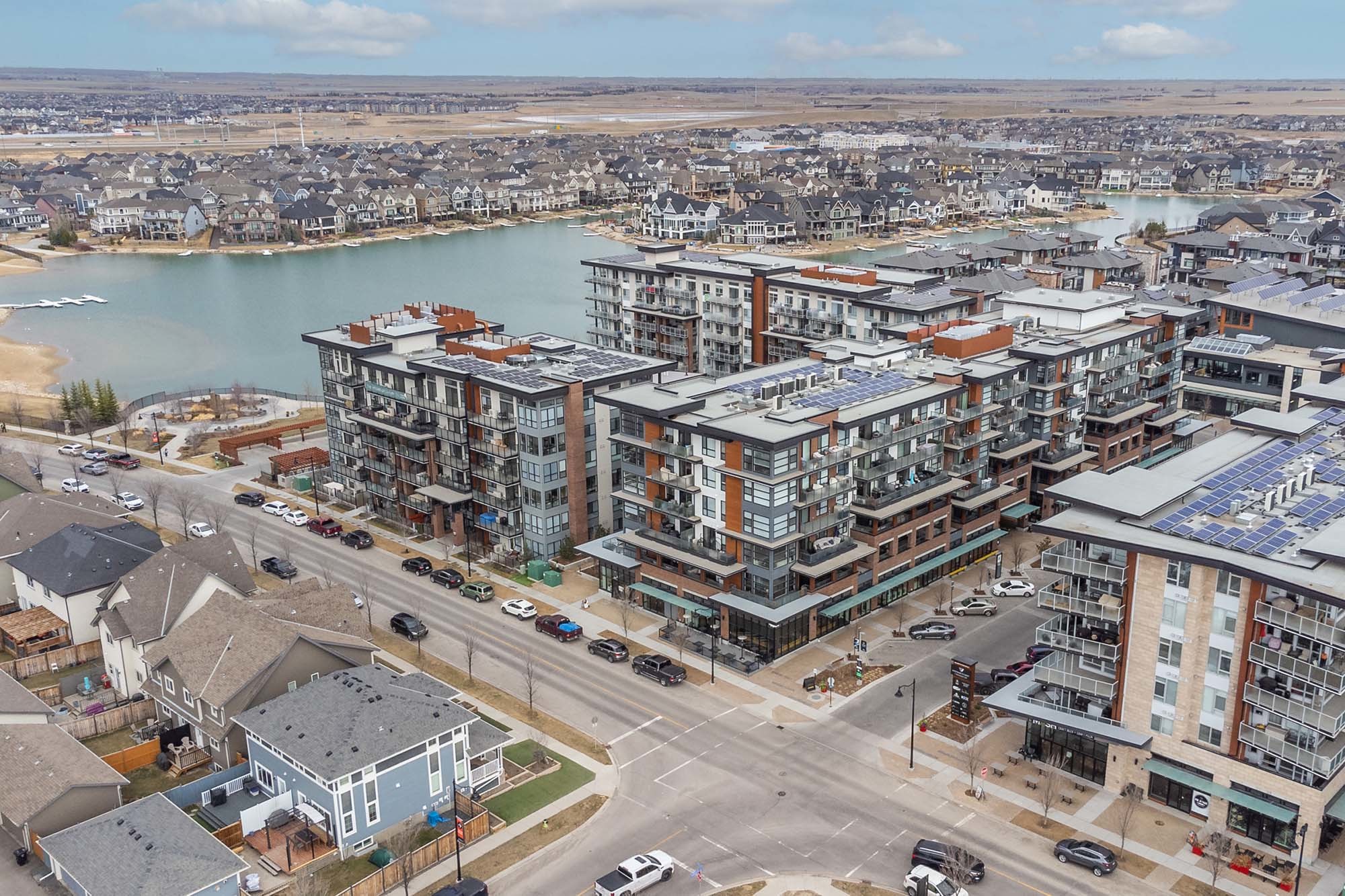 An aerial drone photograph of Odyssey Westman Village with Jayman built condos for sale, apartments for rent, restaurants, shopping, and nightlife