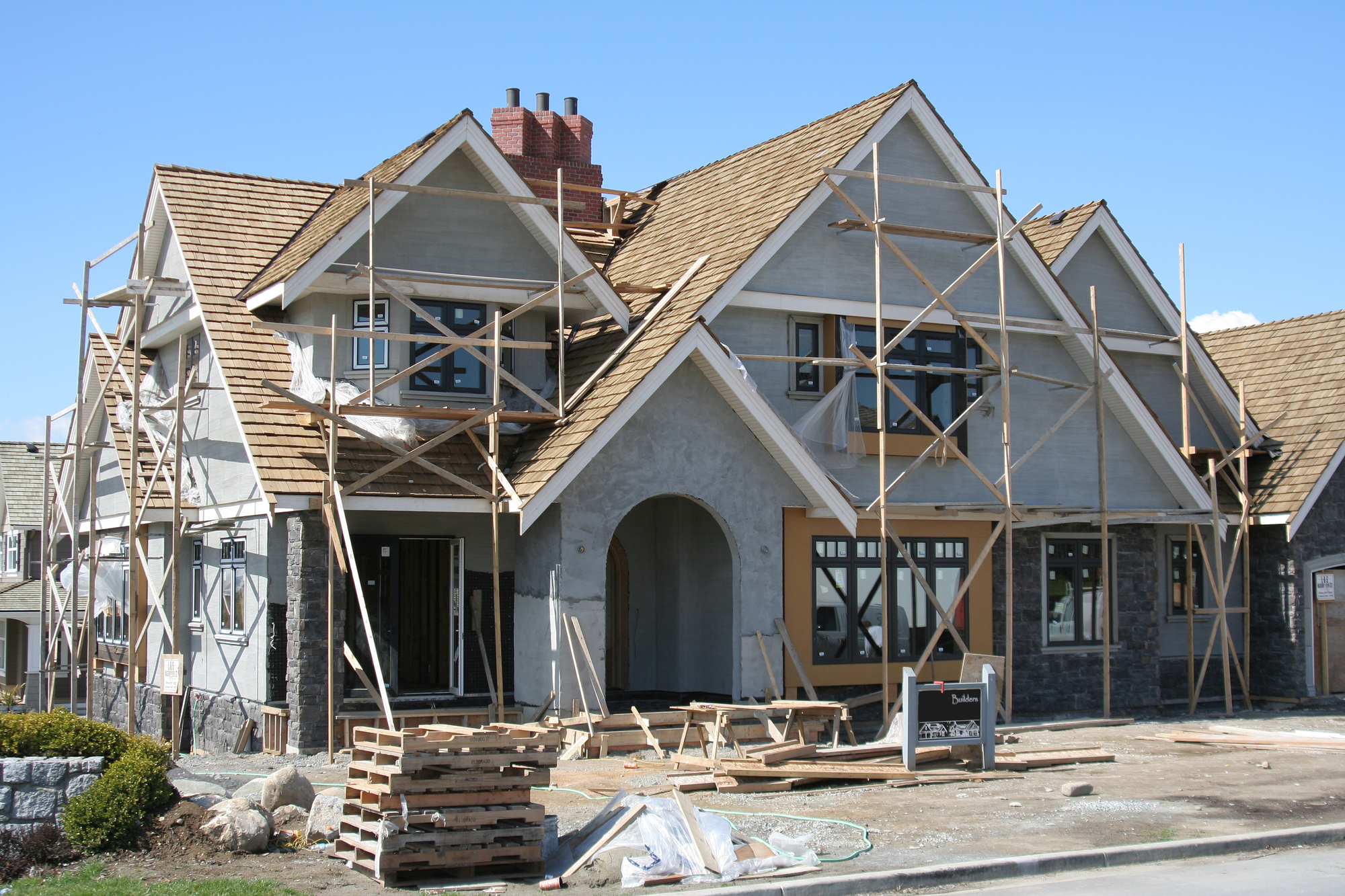 A new single-family home under construction in Calgary, Alberta, Canada with an arched doorway.